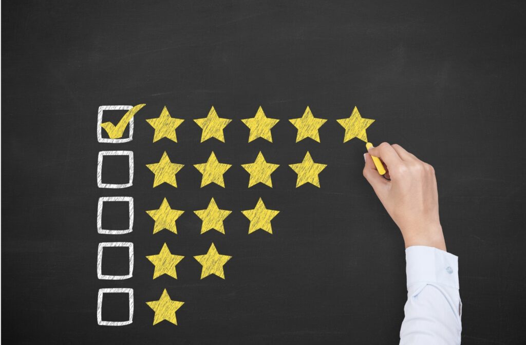 Am arm finishing drawing a 5th star on a chalk board. Next to the 5 stars a box with a check mark. Under the 5 stars, 4,3,2,1