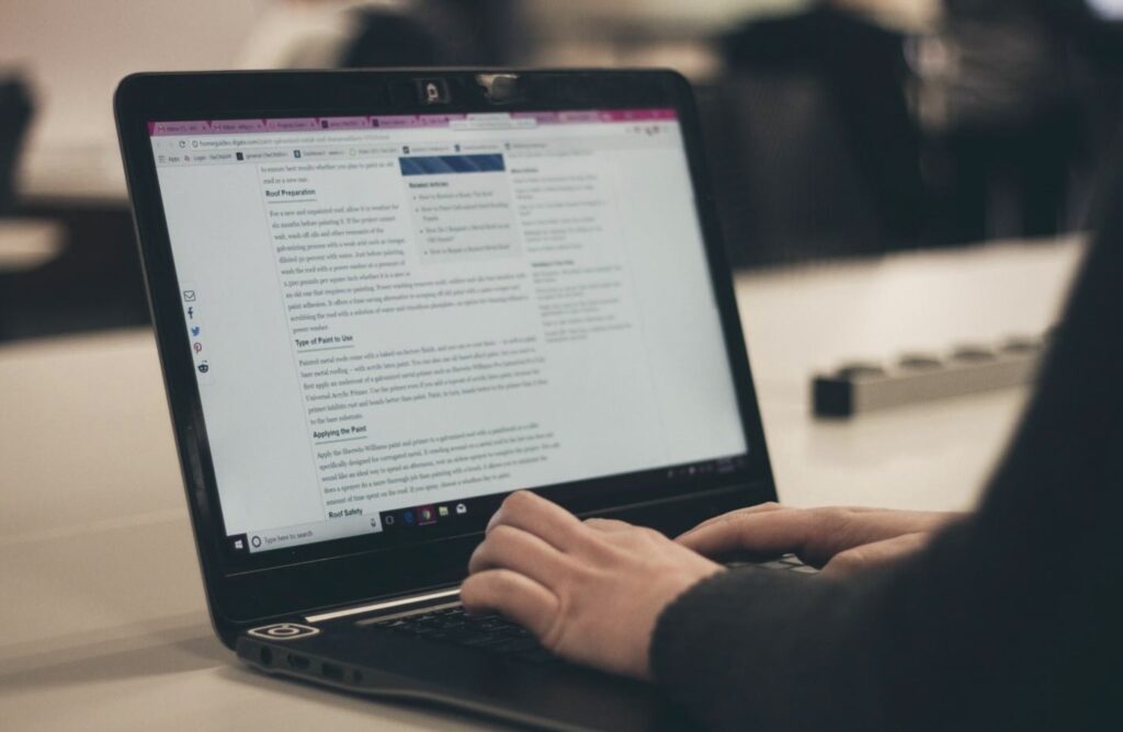 A person typing at a laptop.